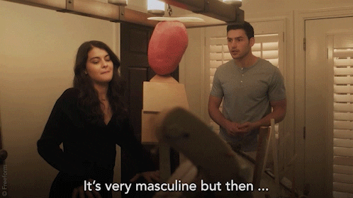 A couple discussing an artwork, which represents the transition from masculine to feminine energy