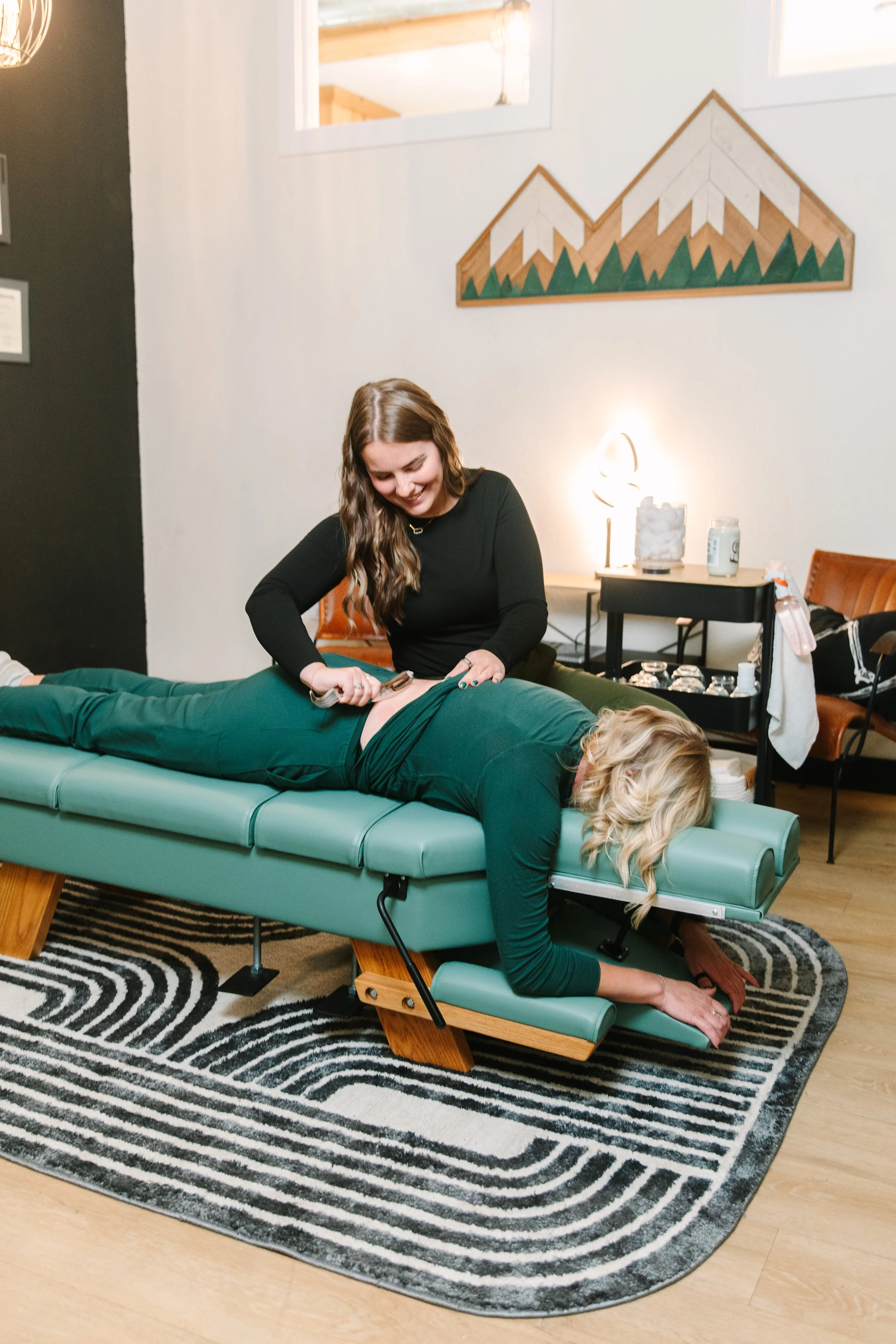 A person receiving a tattoo on their shoulder from an artist.