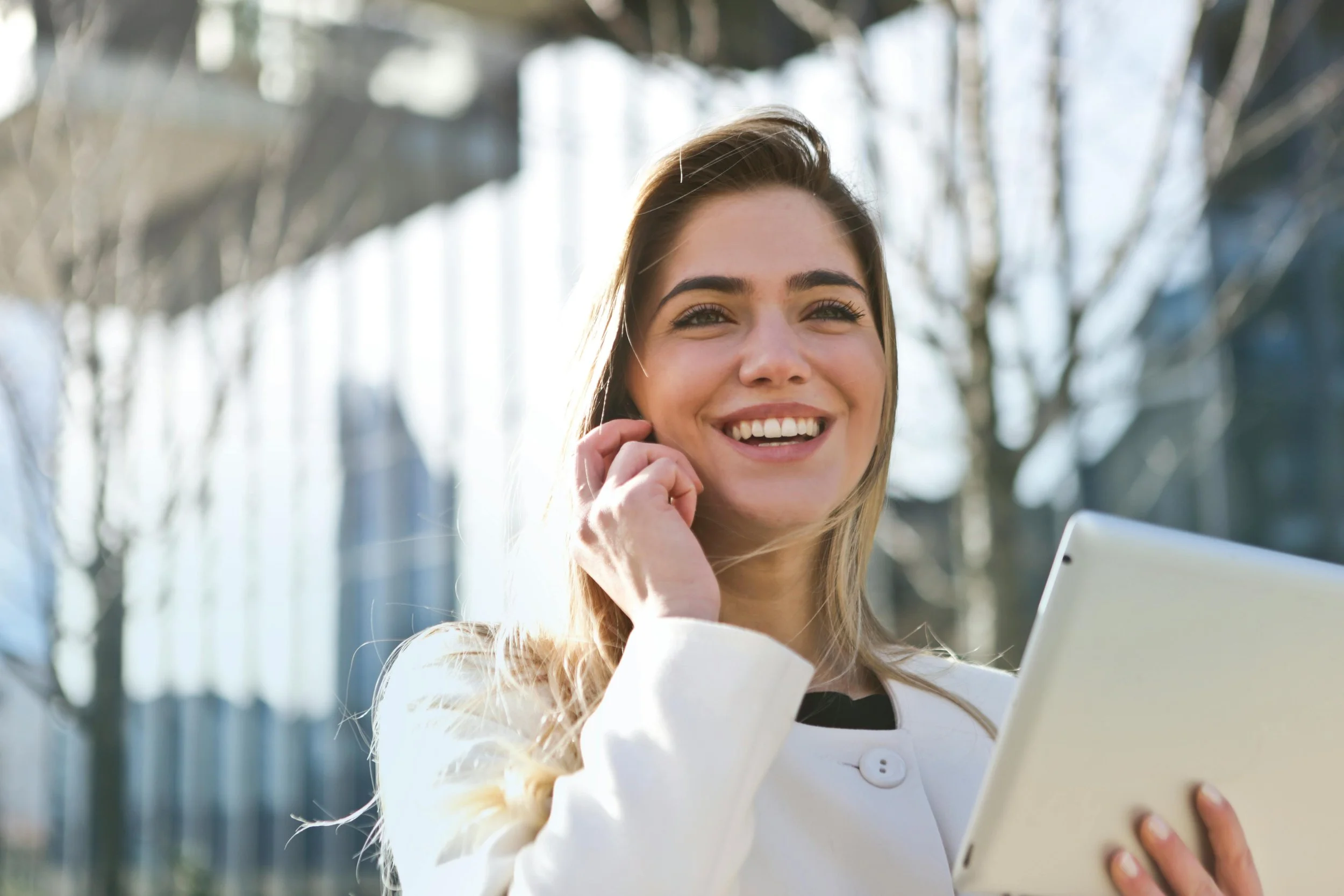 Professional woman walking outside while talking on the phone, representing support and connection in depression therapy.