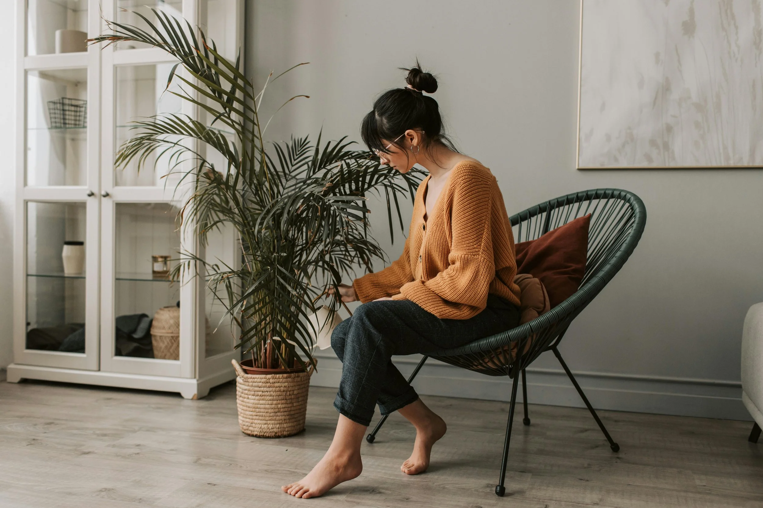 Woman watering her plants, representing care, growth, and healing in depression therapy.