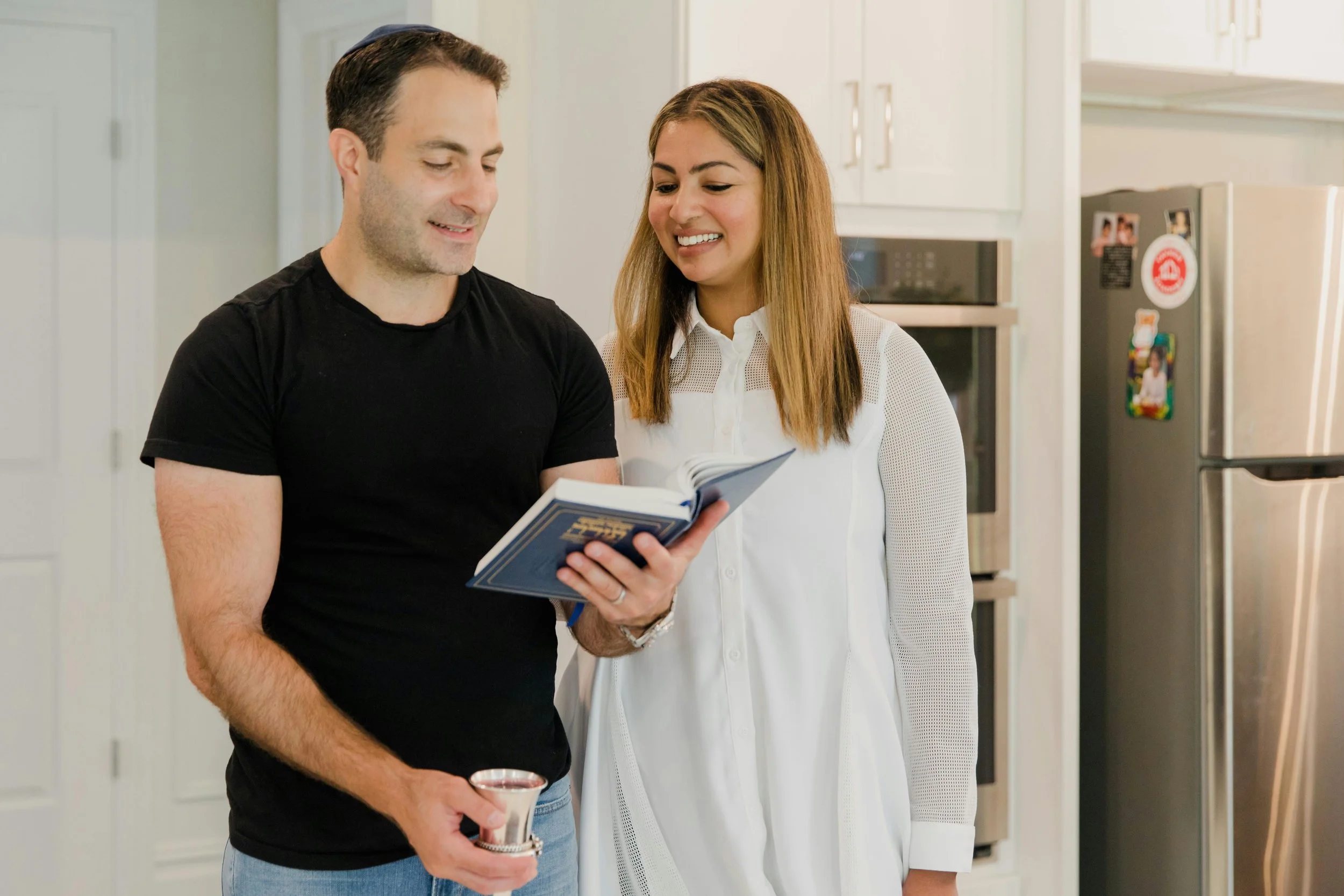 Couple standing together in their kitchen, reflecting connection and shared values.