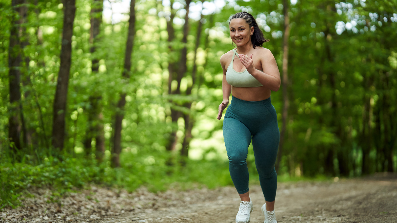 Woman jogging outside, representing rebuilding energy and capacity through trauma therapy.
