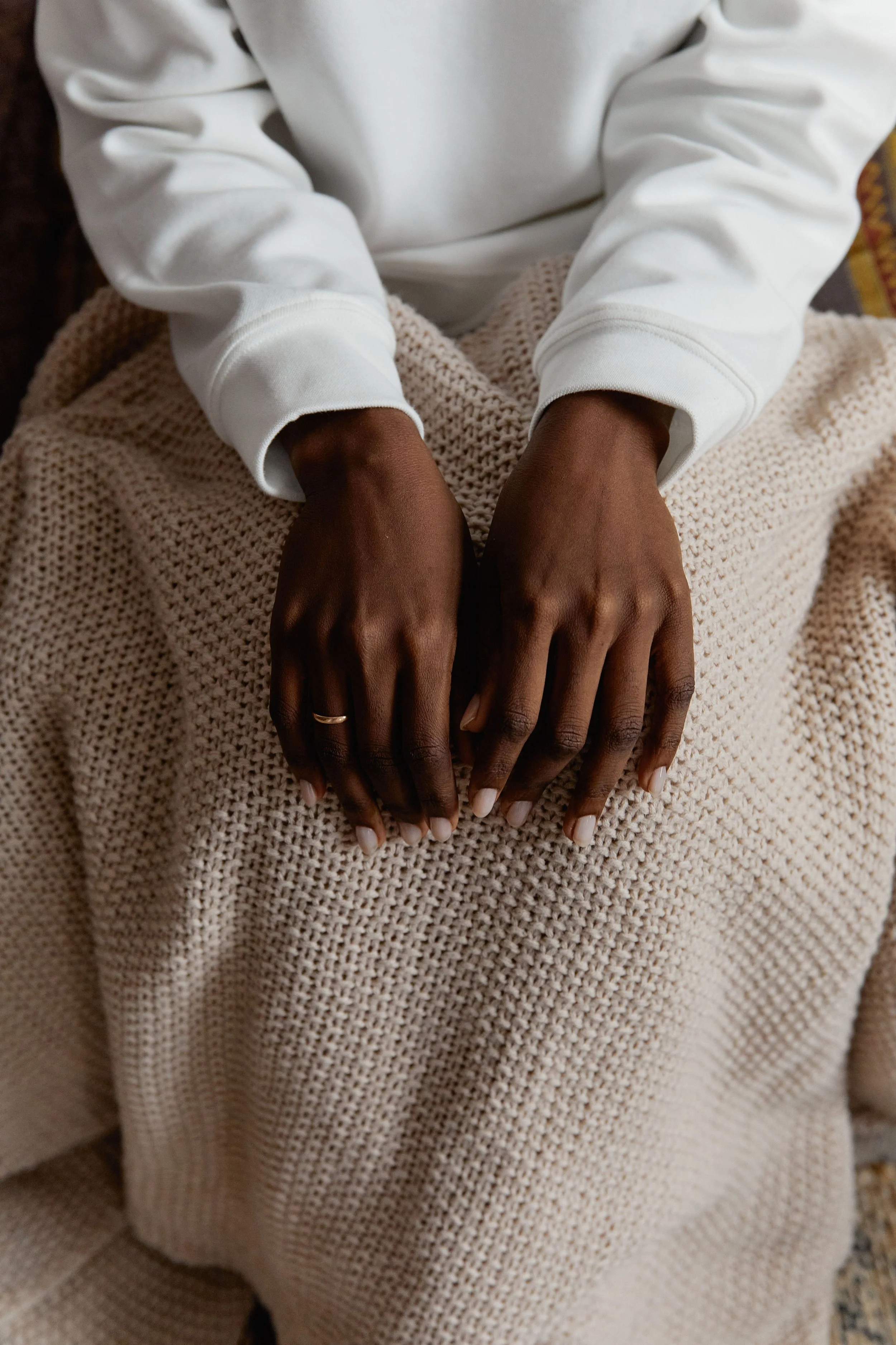 hands resting quietly representing IFS anxiety therapy session New York
