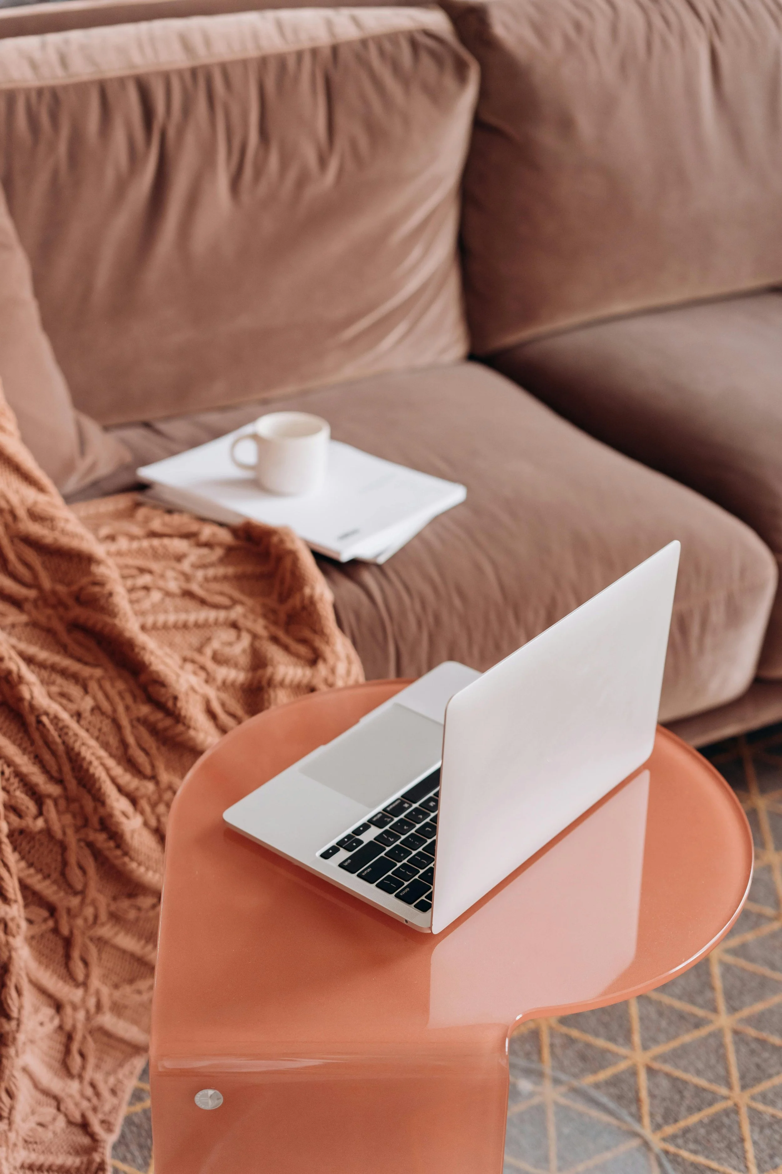 A cozy couch with an open laptop, symbolizing the start of compassionate virtual anxiety therapy in New York with MYAP Therapy.
