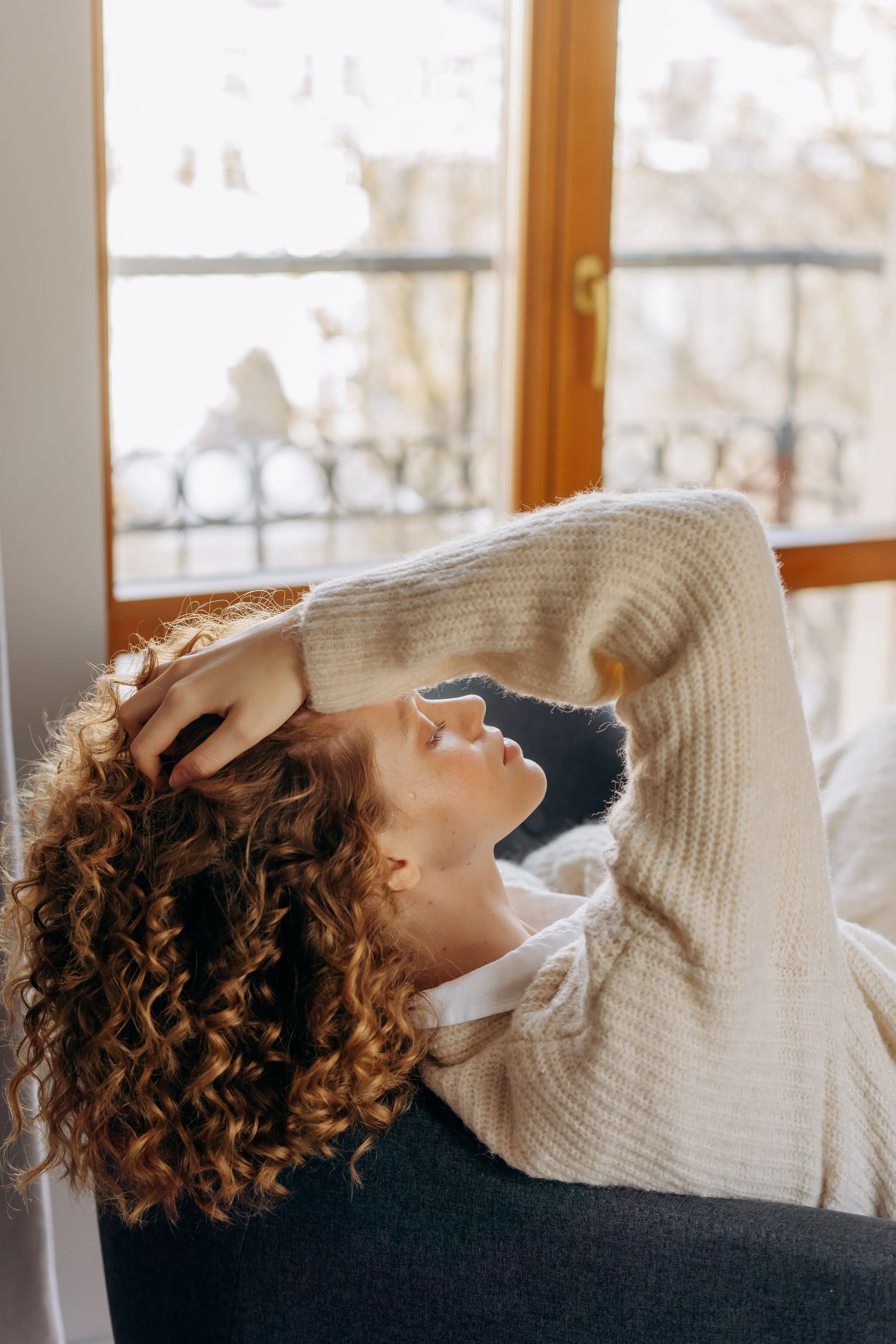 person sitting by window representing IFS therapy for Jewish adults anxiety New York City