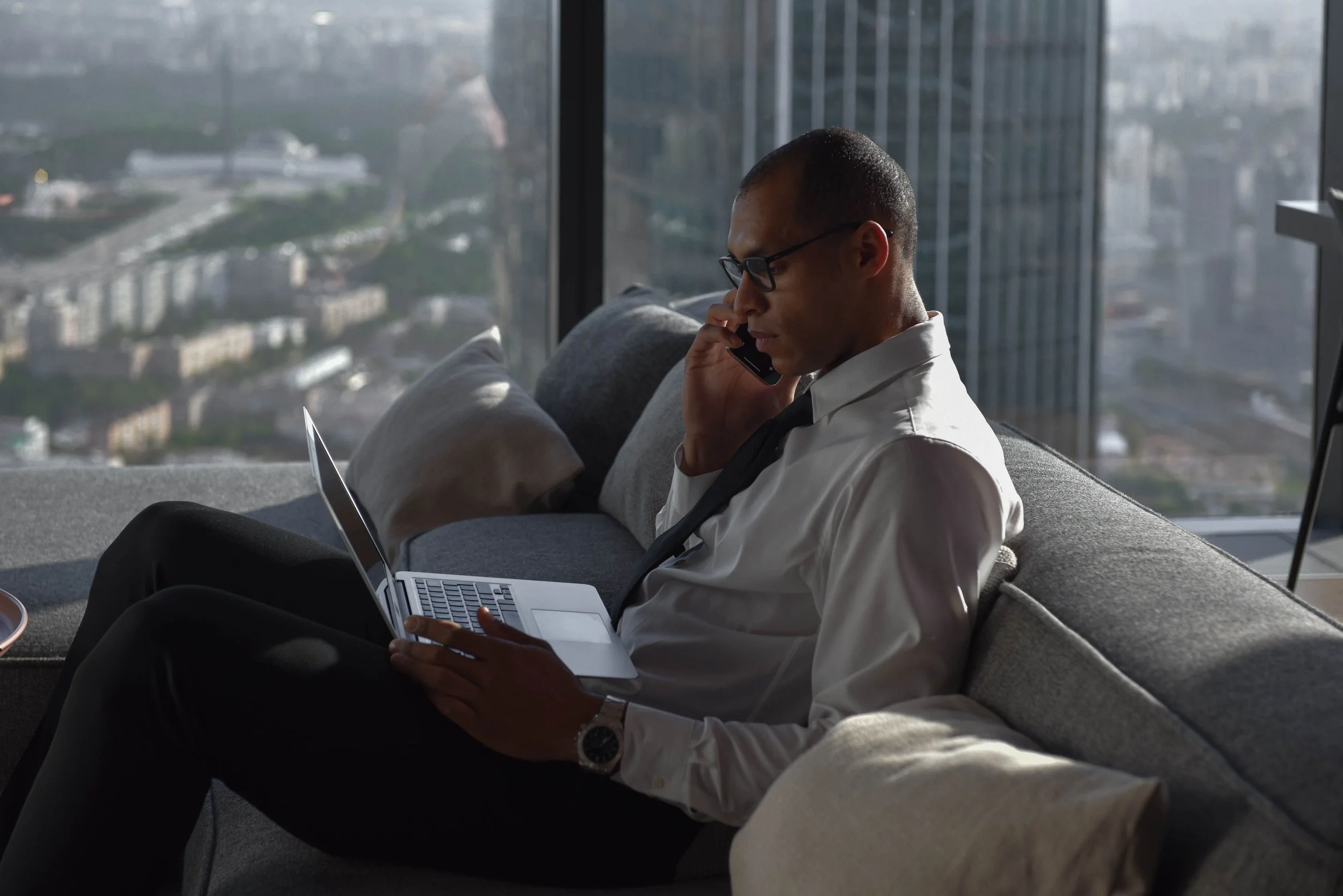 man at desk with city view representing therapy for men anxiety New York City IFS