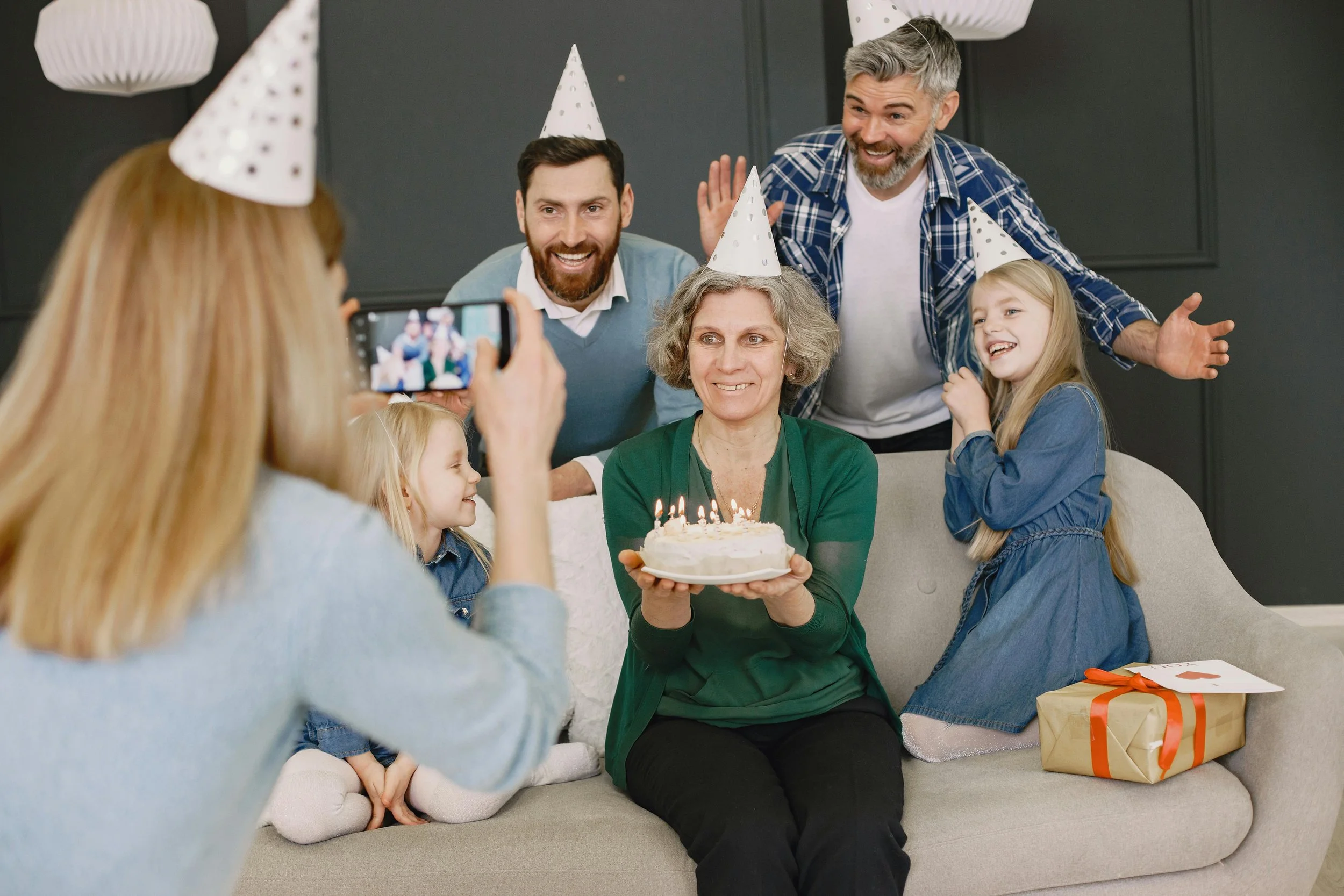 Multigenerational family gathered together celebrating a birthday, representing connection across generations.