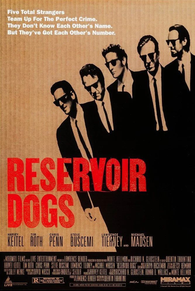 The movie poster for 'Reservoir Dogs' features five men in black suits and black sunglasses, standing side by side against a beige background. The film's title is in large red letters, with the tagline and cast names above and below.