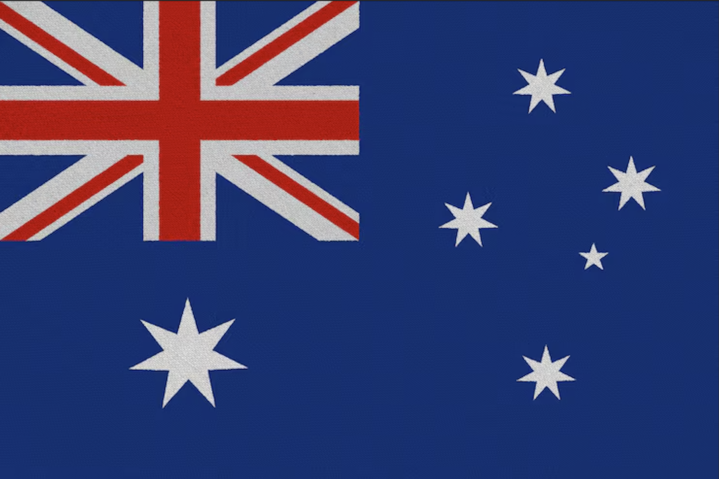 Australian flag featuring a blue background, Union Jack in the upper left corner, and six white stars of varying sizes, including the Commonwealth Star below the Union Jack and the Southern Cross constellation on the right.