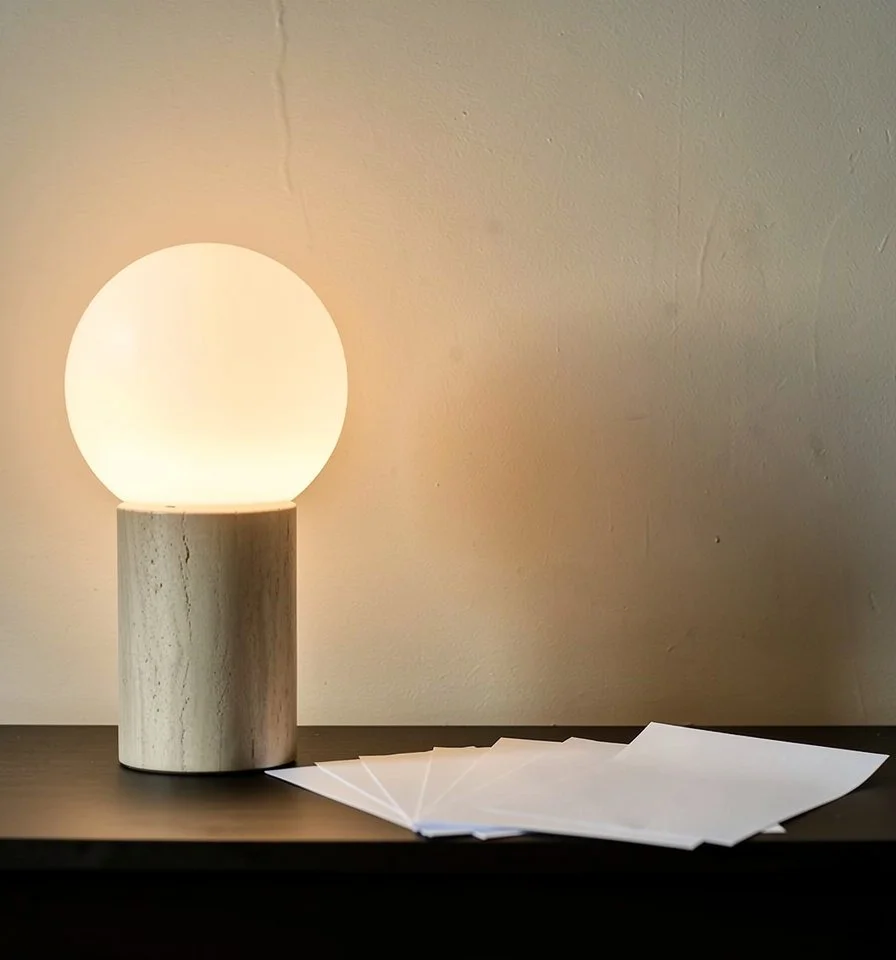 Picture of small table with lamp and white paper