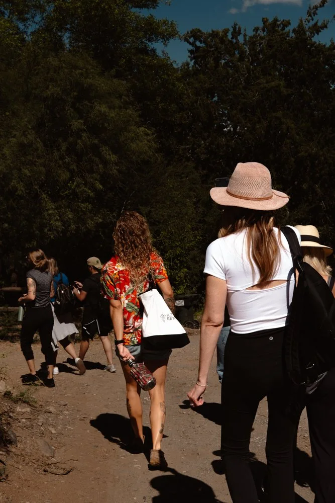 A group of people walking on a dirt path experiencing retreat planning systems.