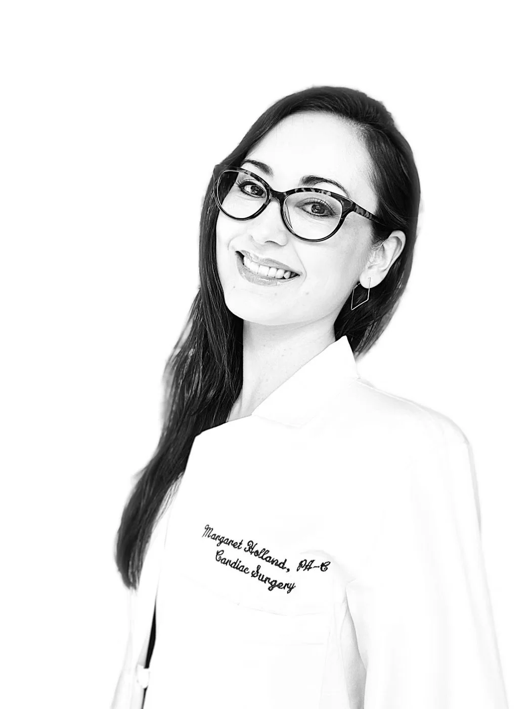 Black and white portrait of a smiling woman wearing glasses and a white coat with embroidered text that reads, 'Margaret Holland, DMD, Candie Surgery'.