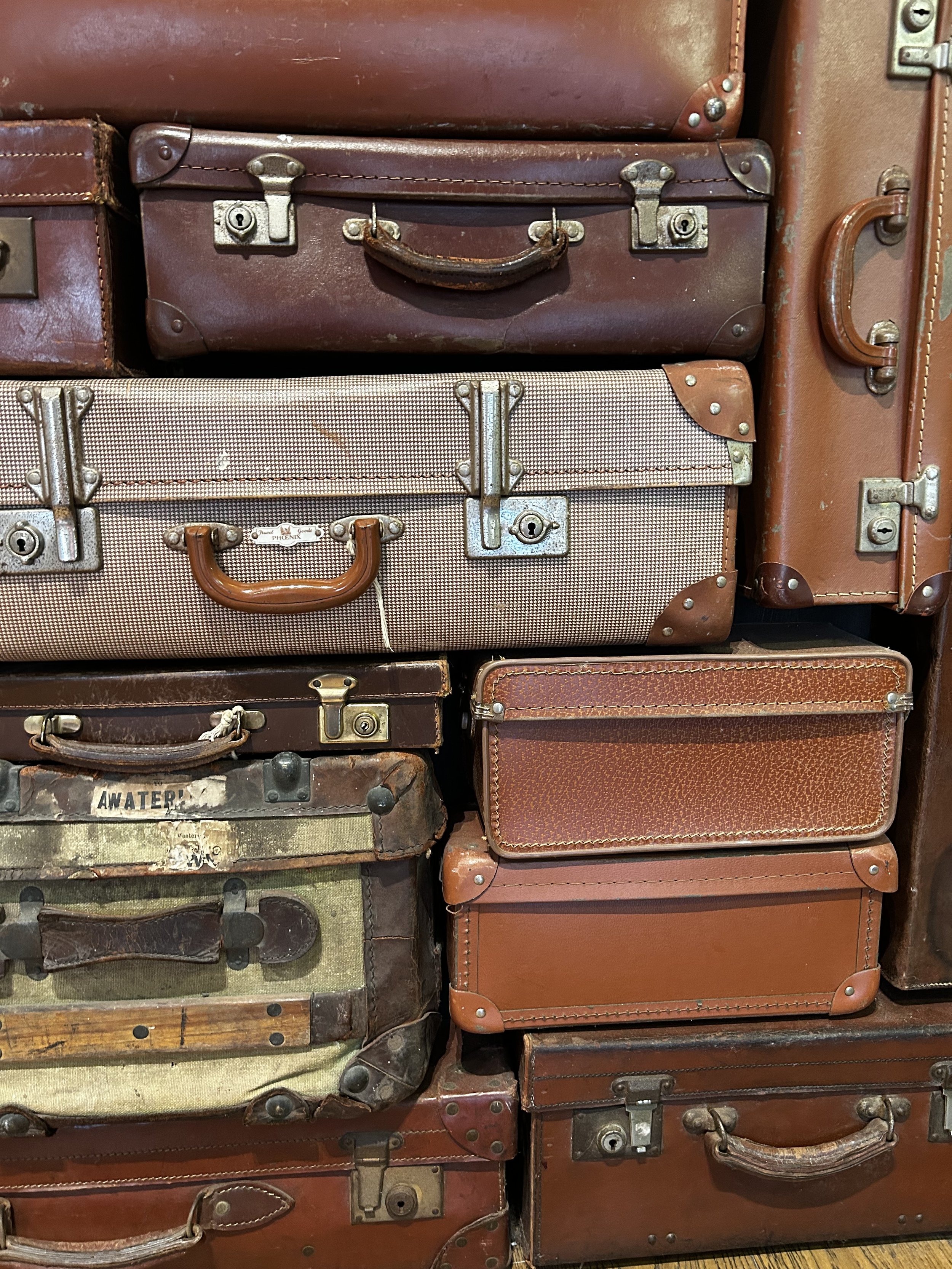 A pile of vintage suitcases