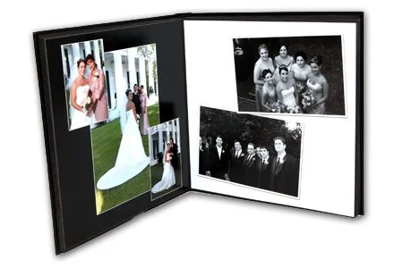 Open photo album displaying wedding photos, including a bride in a wedding dress and group pictures of guests.