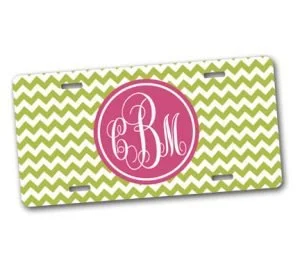 A rectangular object with a green and white zigzag pattern background and a pink circle in the center containing white cursive monogram initials C, B, M.