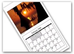 A calendar page for February 2023 with a sunset or sunrise scene of a tree near water reflected in the sky.