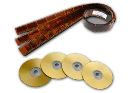 A strip of 35mm film and four gold-colored DVDs or CDs.