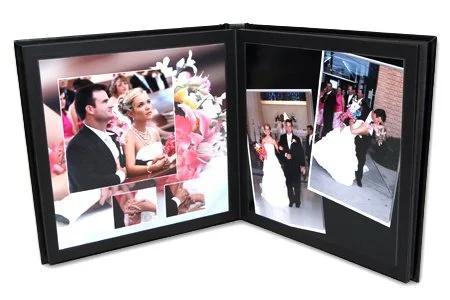 Open photo frame displaying wedding photos of a bride and groom with guests at a reception.