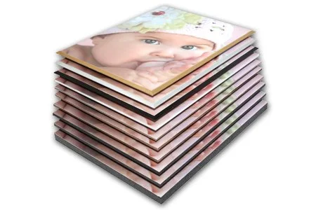 Stack of photo prints featuring a baby with blue eyes.