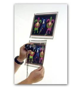 Person holding a Nintendo 3DS with a colorful digital illustration of cartoon creatures on the screen.