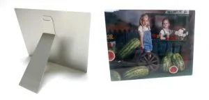 A white stand with a flat surface and a separate boxed toy set featuring two dolls and watermelon slices.