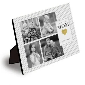 A framed photo collage of four black-and-white pictures of children with a message "Love You Mom" and a gold heart.