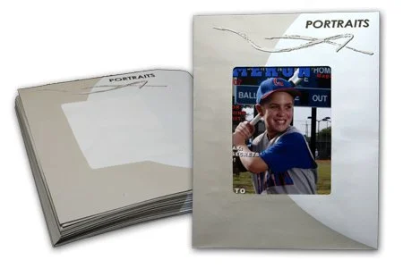 Open photo album with a picture of a young boy in a baseball uniform