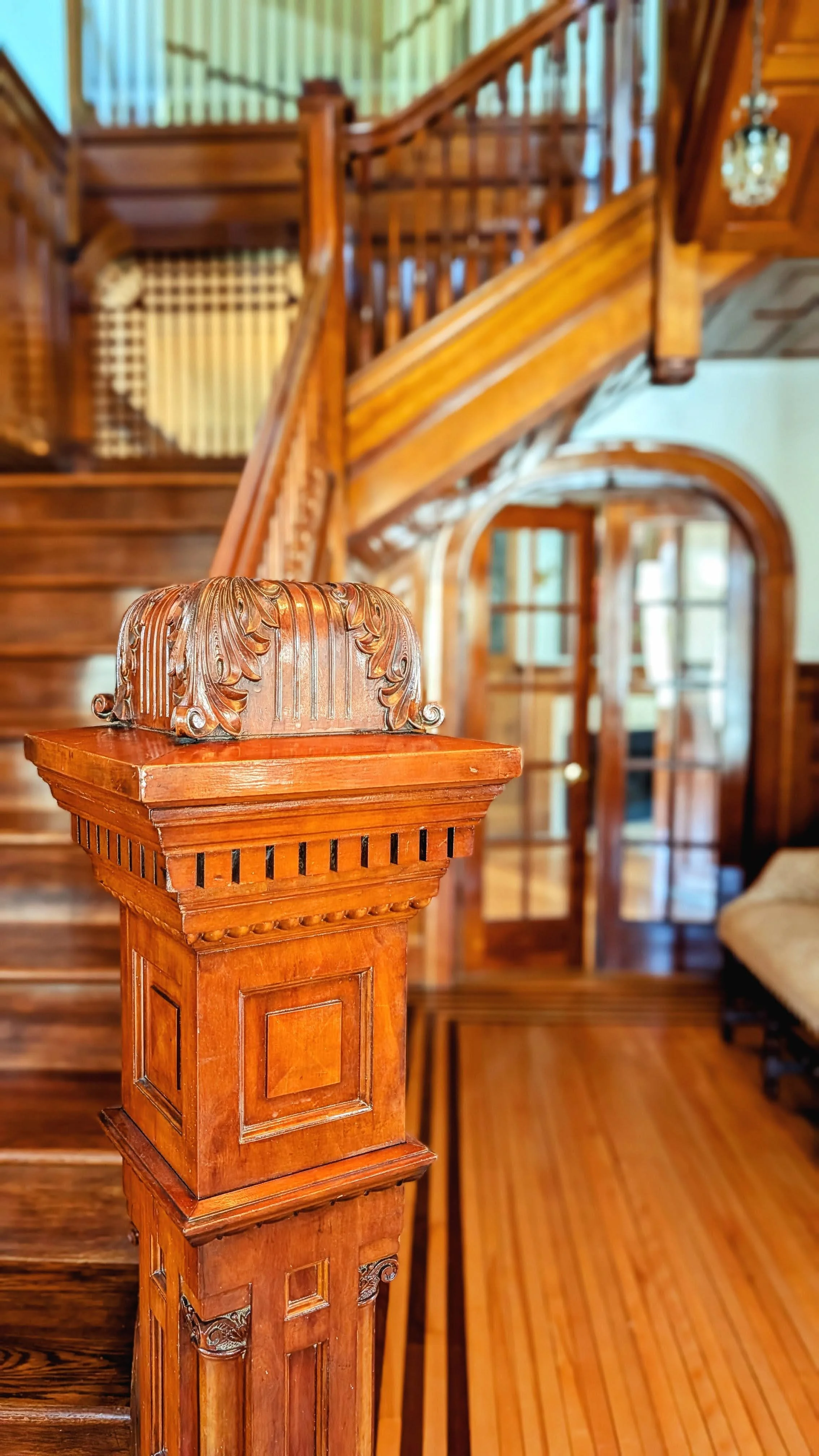 A view of the historic staircase and ornate newel post as you enter the home.