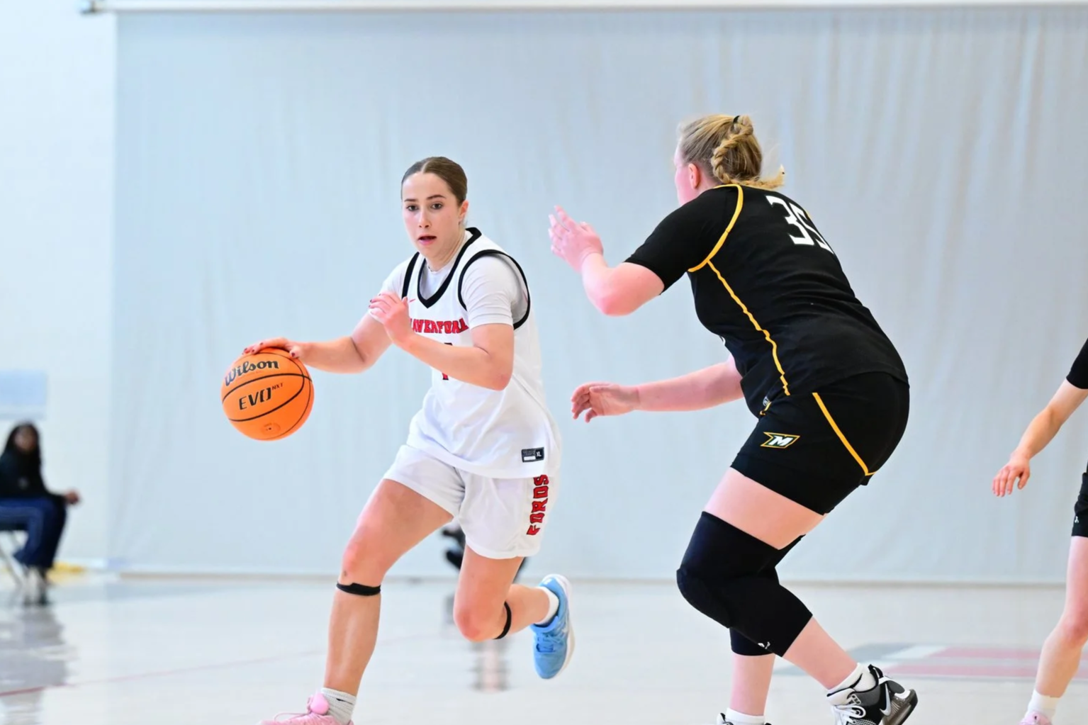 A Haverford women's basketball player dribbles down the court.