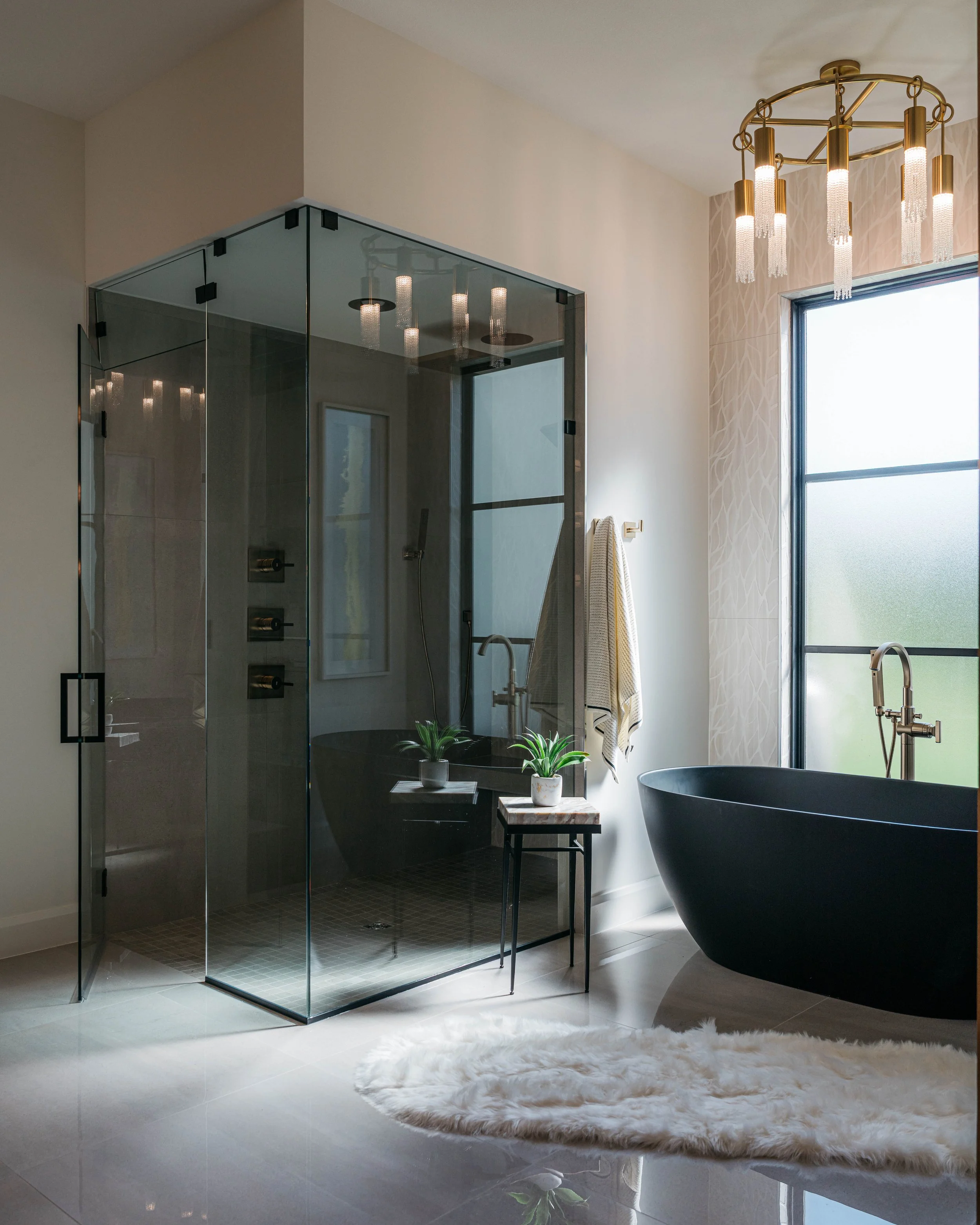 Luxury custom bathroom featuring a glass-enclosed shower, freestanding soaking tub, and elevated modern finishes.