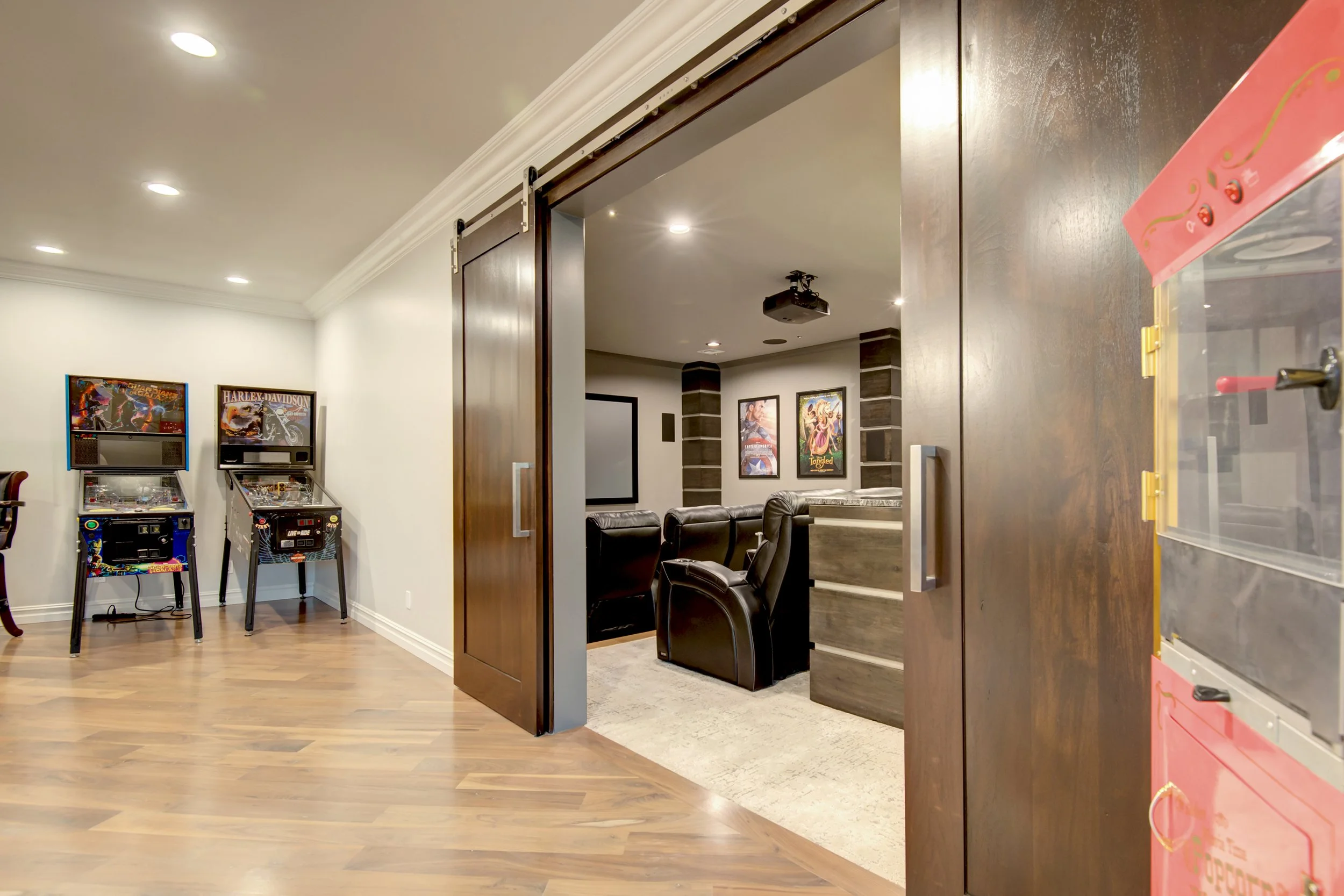 High-end custom game room with built-in storage, open layout, and dedicated entertainment areas.