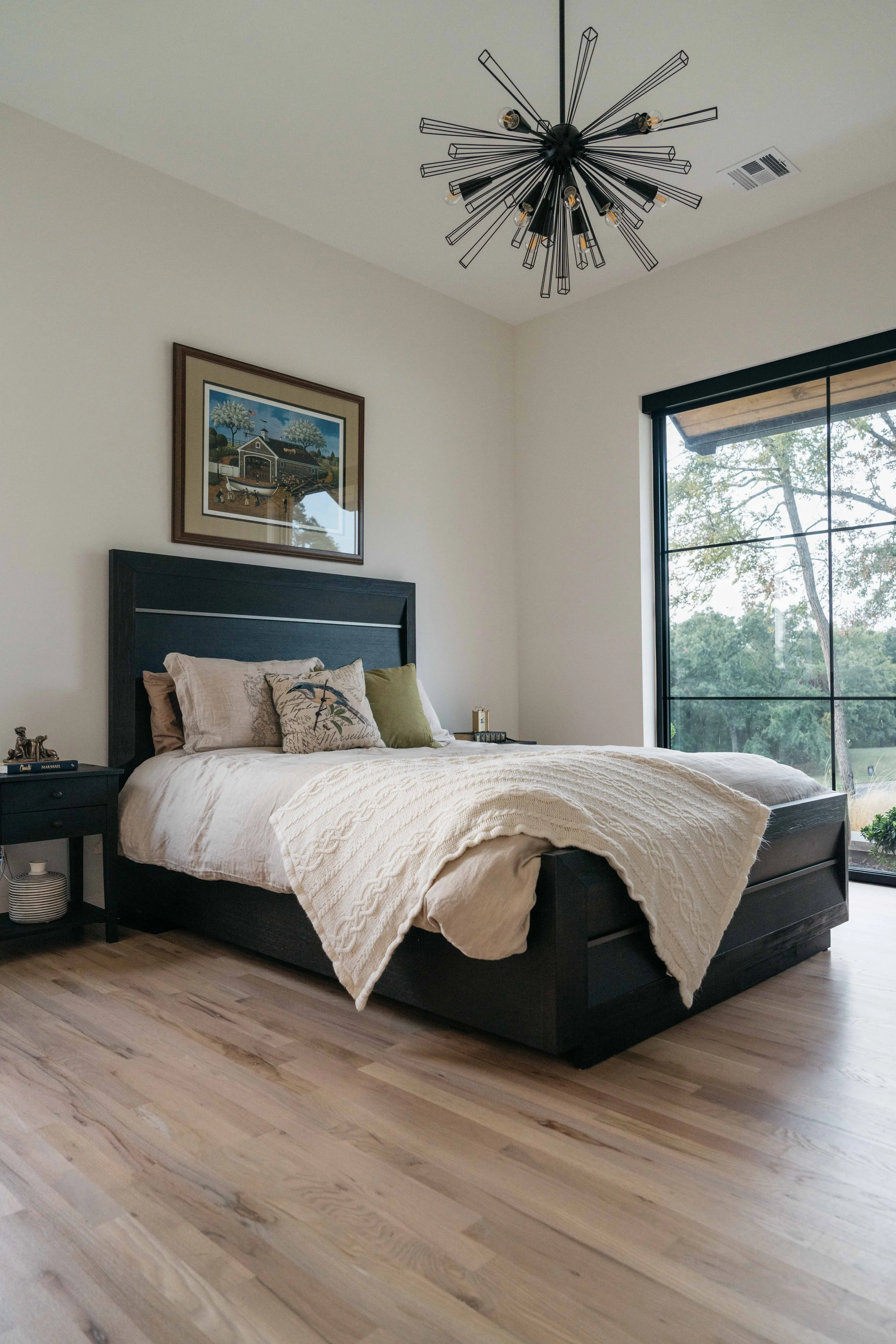 Luxury custom bedroom with tailored furnishings, natural wood flooring, and serene mountain-inspired design.