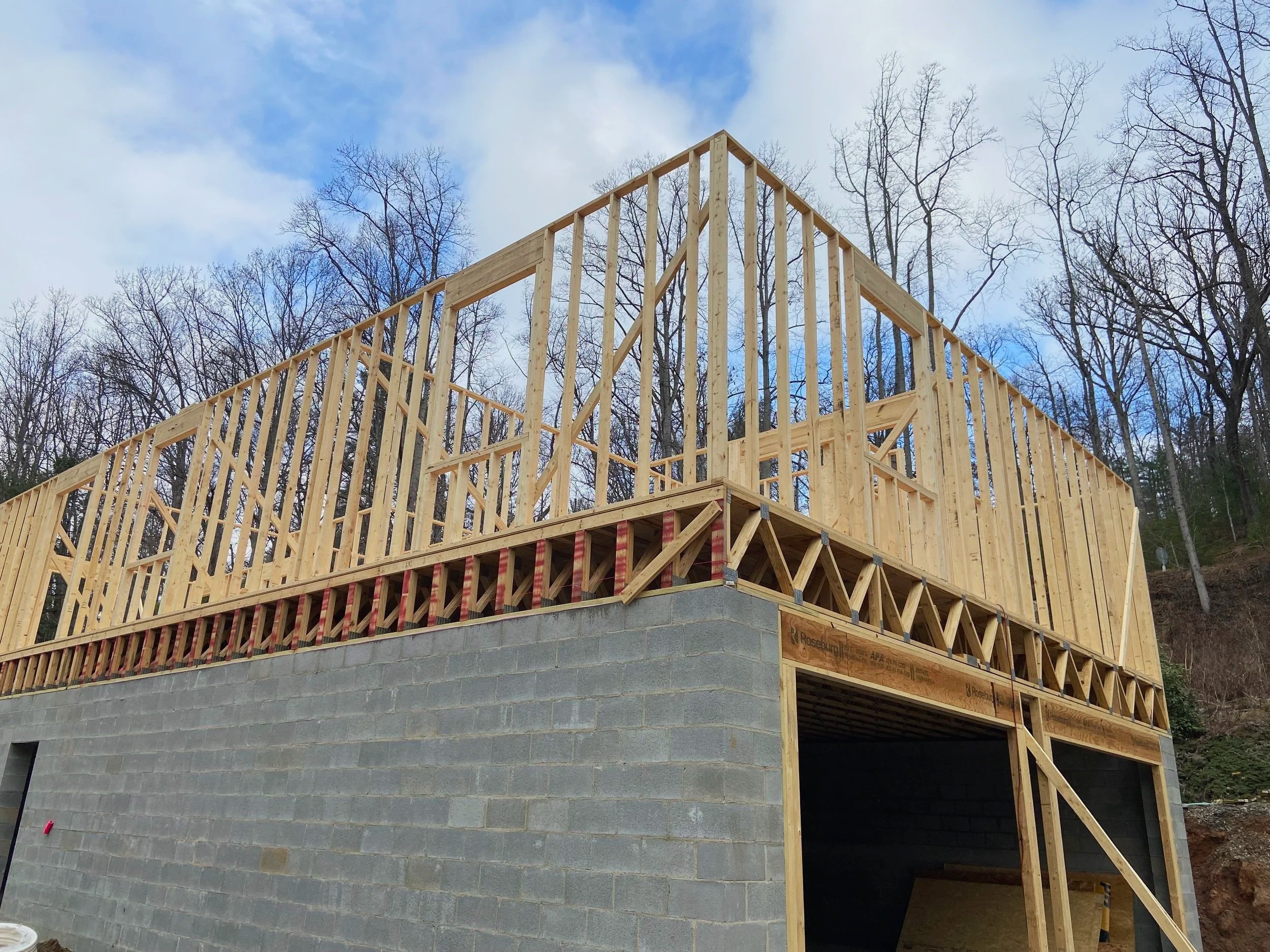 Wood framing construction on top of a concrete block foundation.