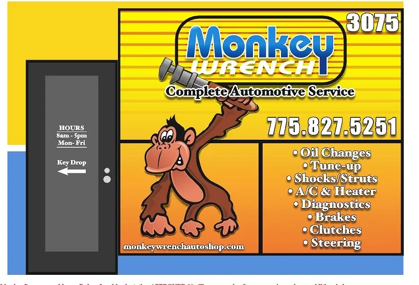 A colorful business sign for Monkey Wrench, an automotive service shop. The sign features a cartoon monkey holding a wrench, with information about services offered, contact number, opening hours, and website. The left side has a door labeled "HOURS 