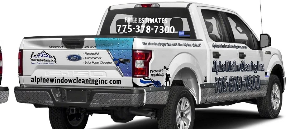 The image features a white pickup truck with advertising for Alpine Window Cleaning Inc. on its sides and rear. The truck displays the company name, contact number, website, and services, along with logos, icons, and graphic elements related to windo
