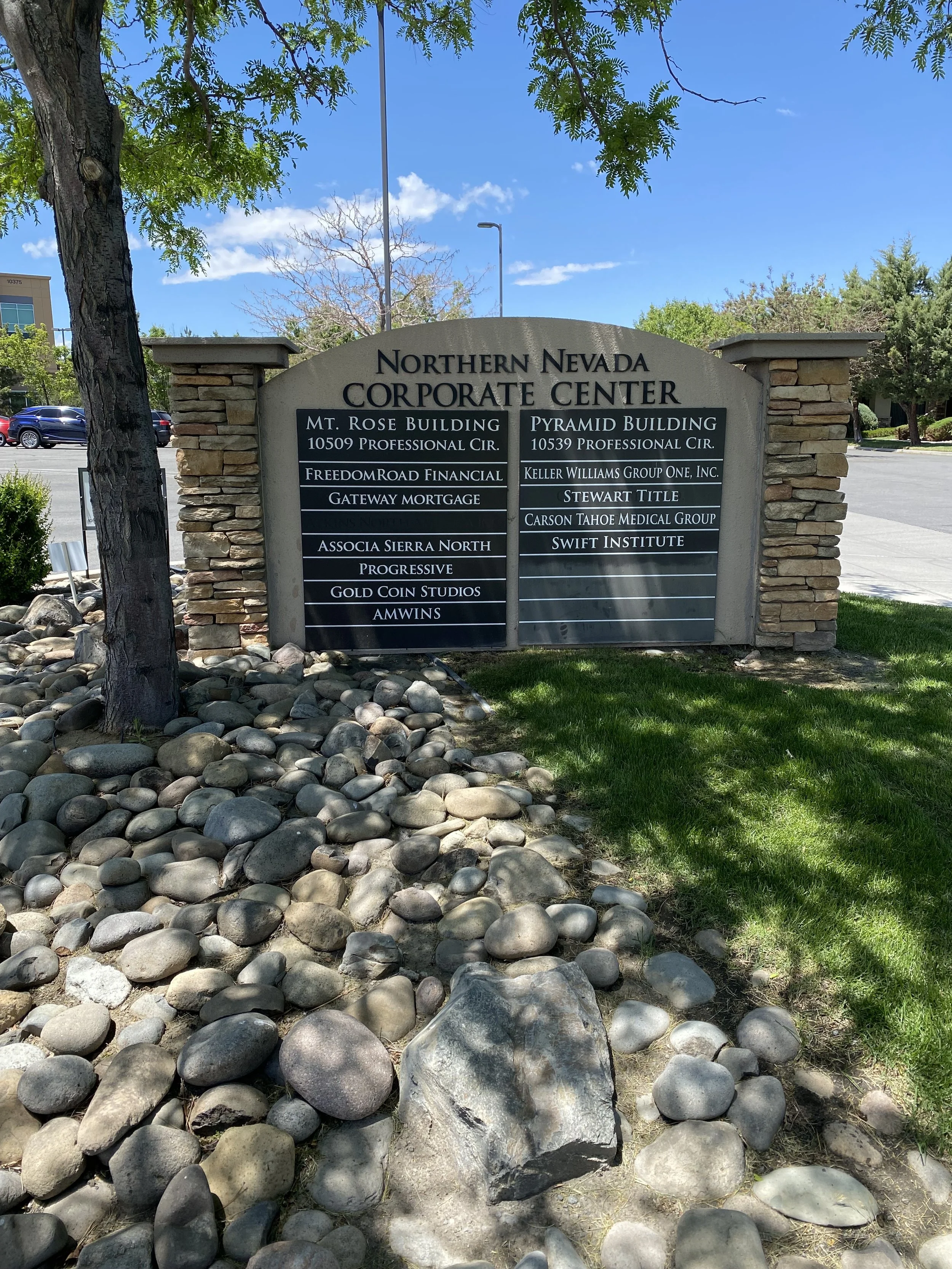 Sign for Northern Nevada Corporate Center listing various buildings and businesses.
