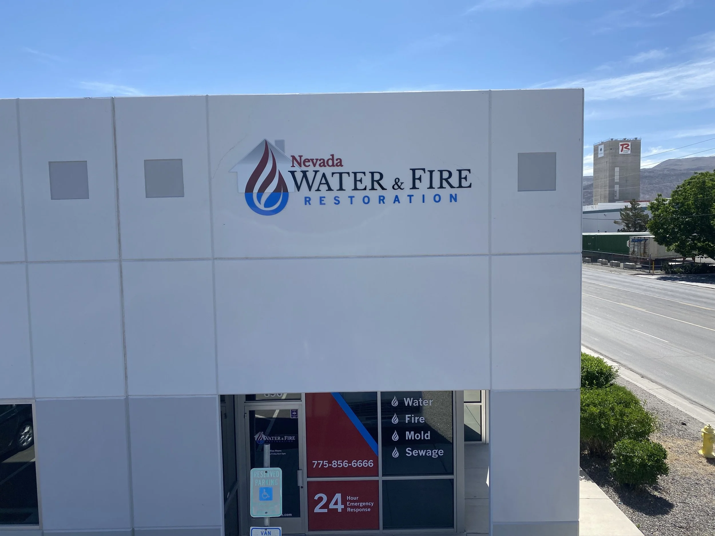 Exterior view of Nevada Water & Fire Restoration building with logo and signage indicating services for water, fire, mold, and sewage restoration.