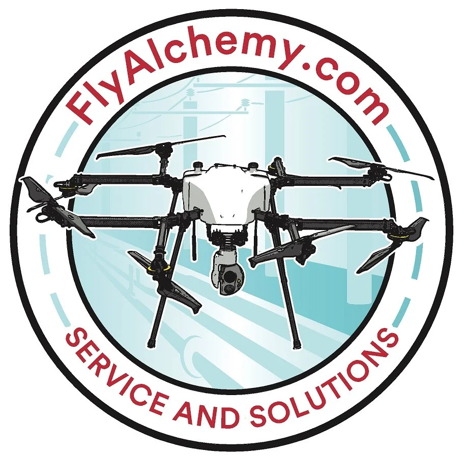A logo featuring a drone with multiple rotors inside a circular border. The border contains the text "FlyAlchemy.com" at the top and "Service and Solutions" at the bottom. The background has a stylized cityscape or industrial setting.