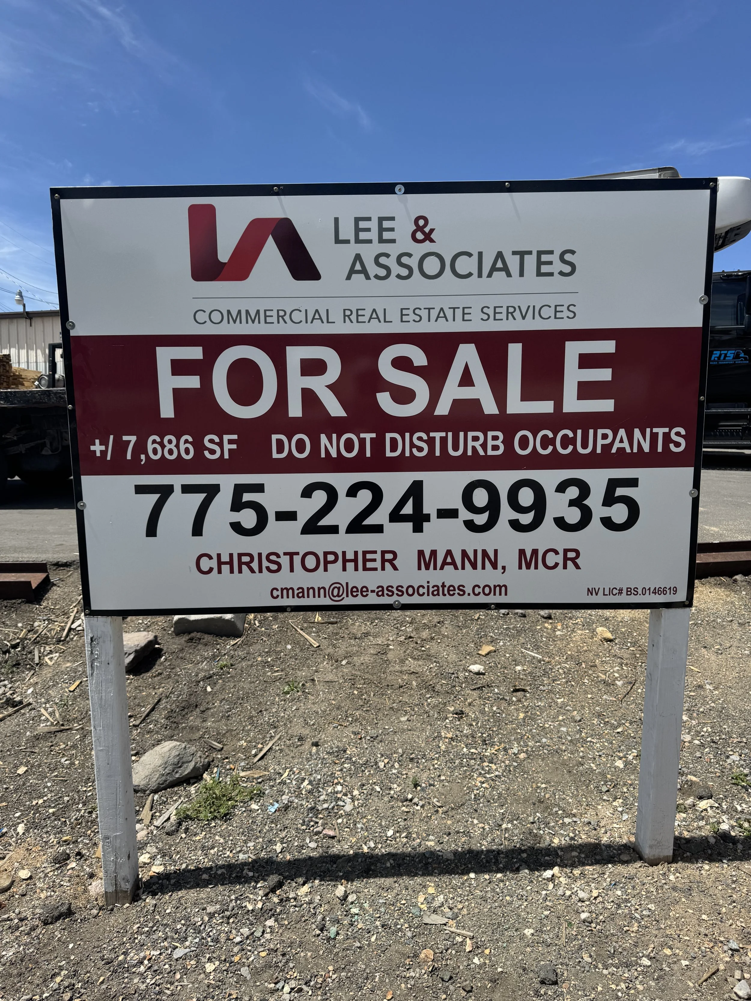For sale sign for commercial real estate with 7,686 square feet, contact number 775-224-9935, email cmann@lee-associates.com, and the name Christopher Mann, MCR.