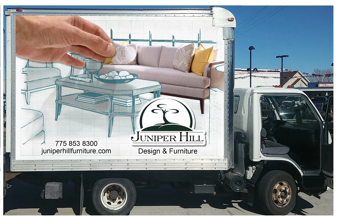 A truck advertising Juniper Hill Design & Furniture features a large graphic of a living room with a sofa, cushions, a coffee table, and a hand touching a cushion, with contact information and logo.