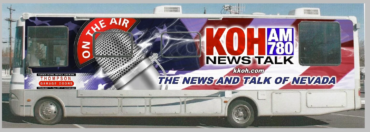 Bus with a large graphic advertisement for KOAH AM 780 news talk radio station, featuring a microphone and the text "ON THE AIR".