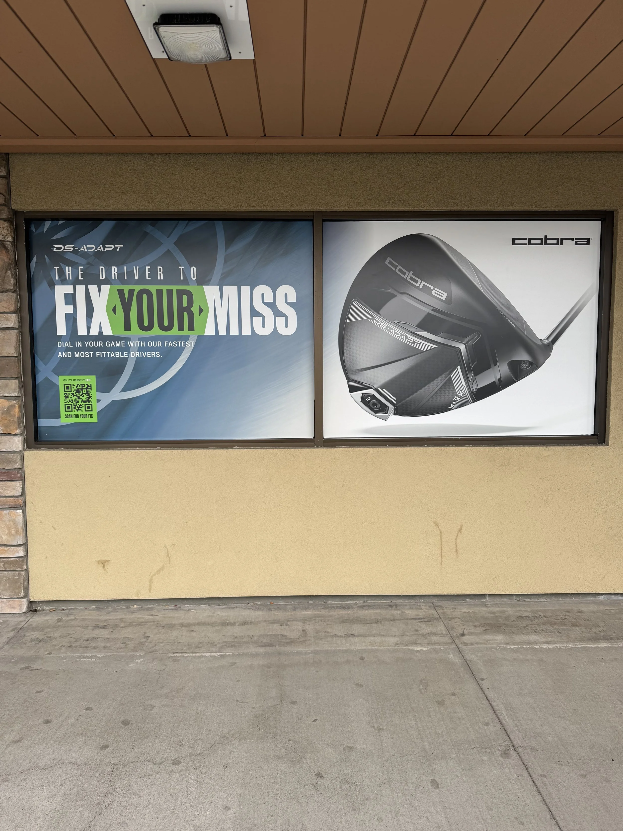 Advertisement for Cobra golf driver, featuring the slogan 'The driver to fix your miss' and an image of a black Cobra golf club.