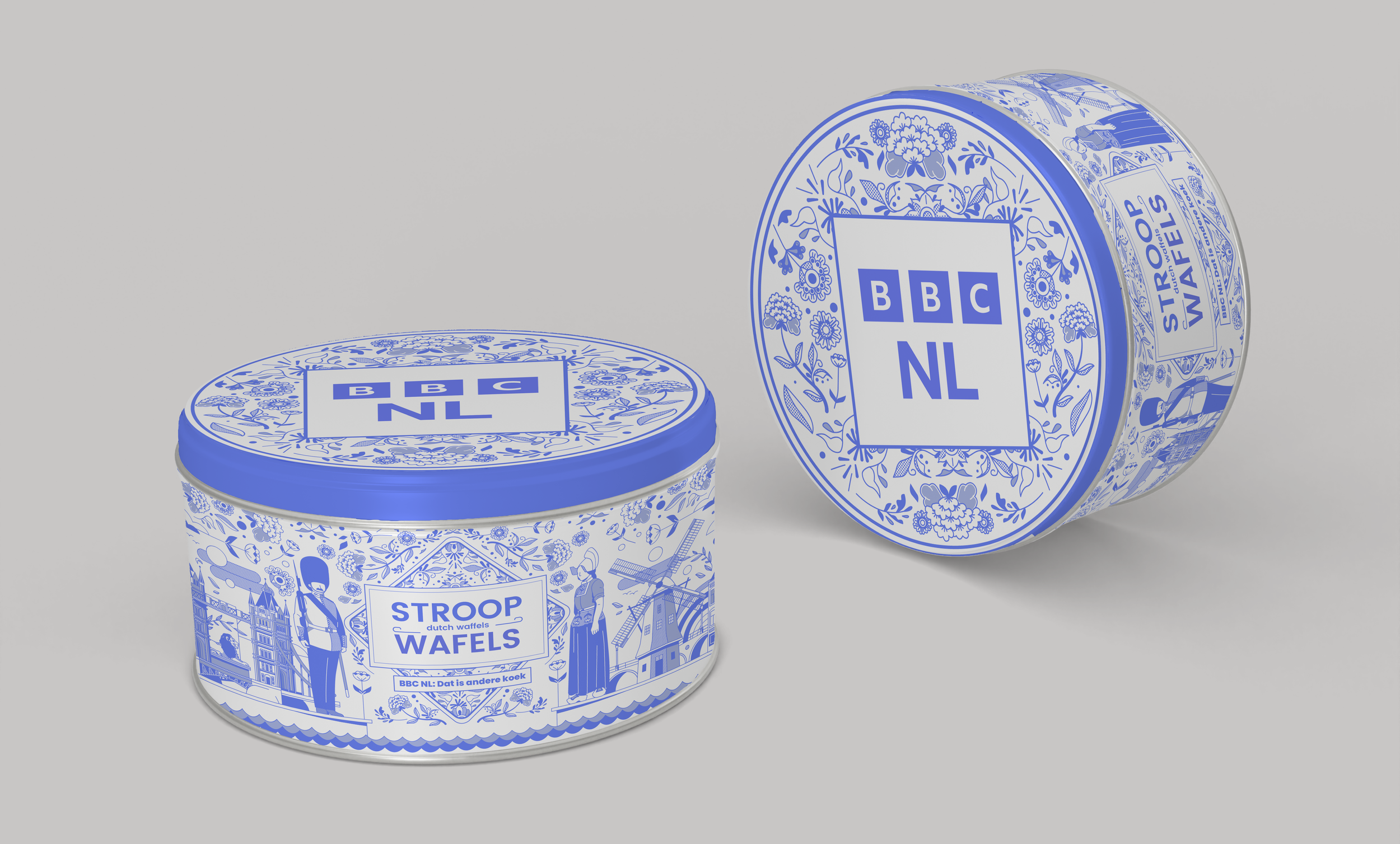 Two cans of Dutch waffles called Stroop Wafels with blue and white Dutch-themed designs, including windmills, a man in traditional Dutch clothing, and floral patterns.