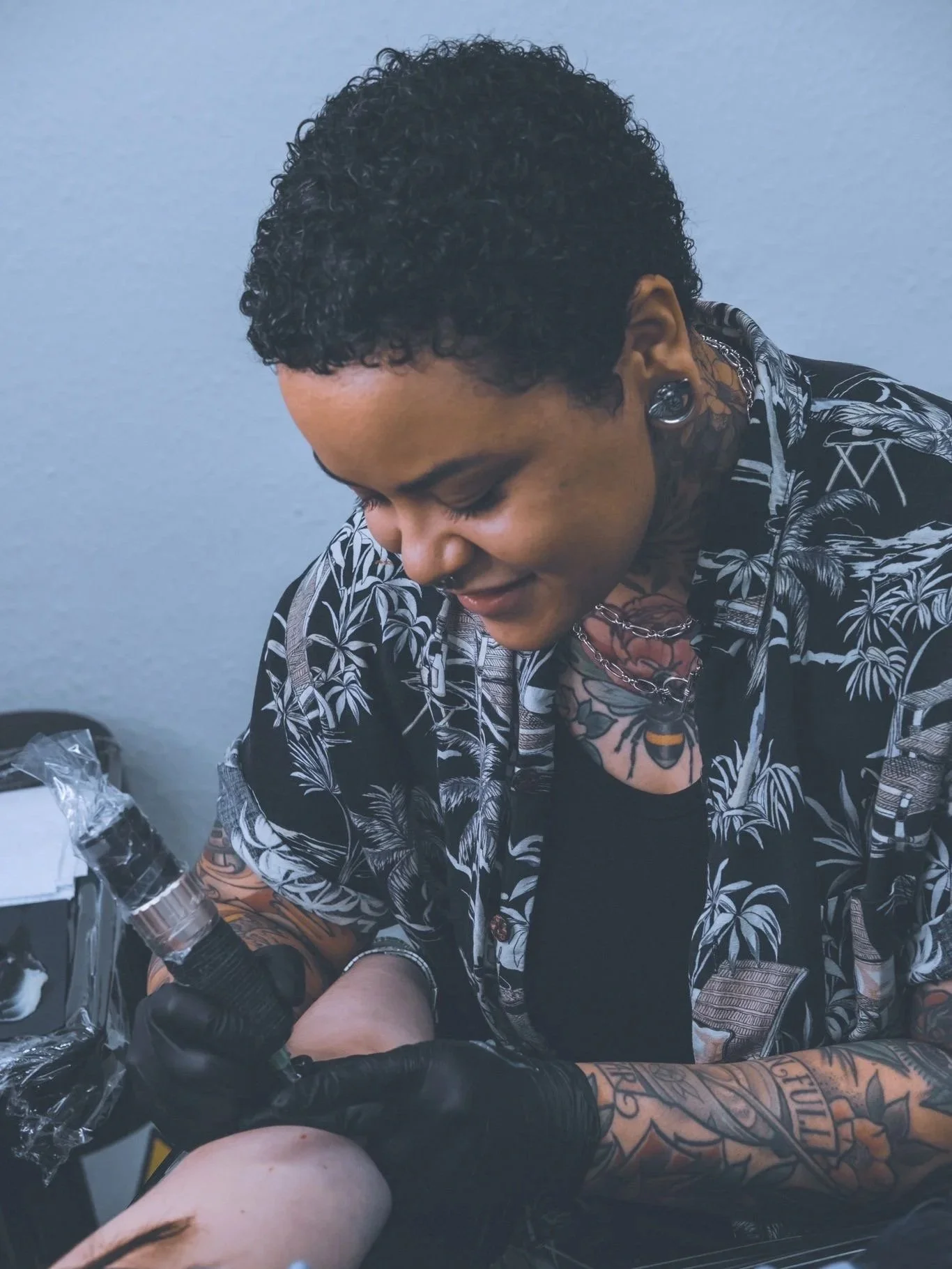 zoazy tattooing a client