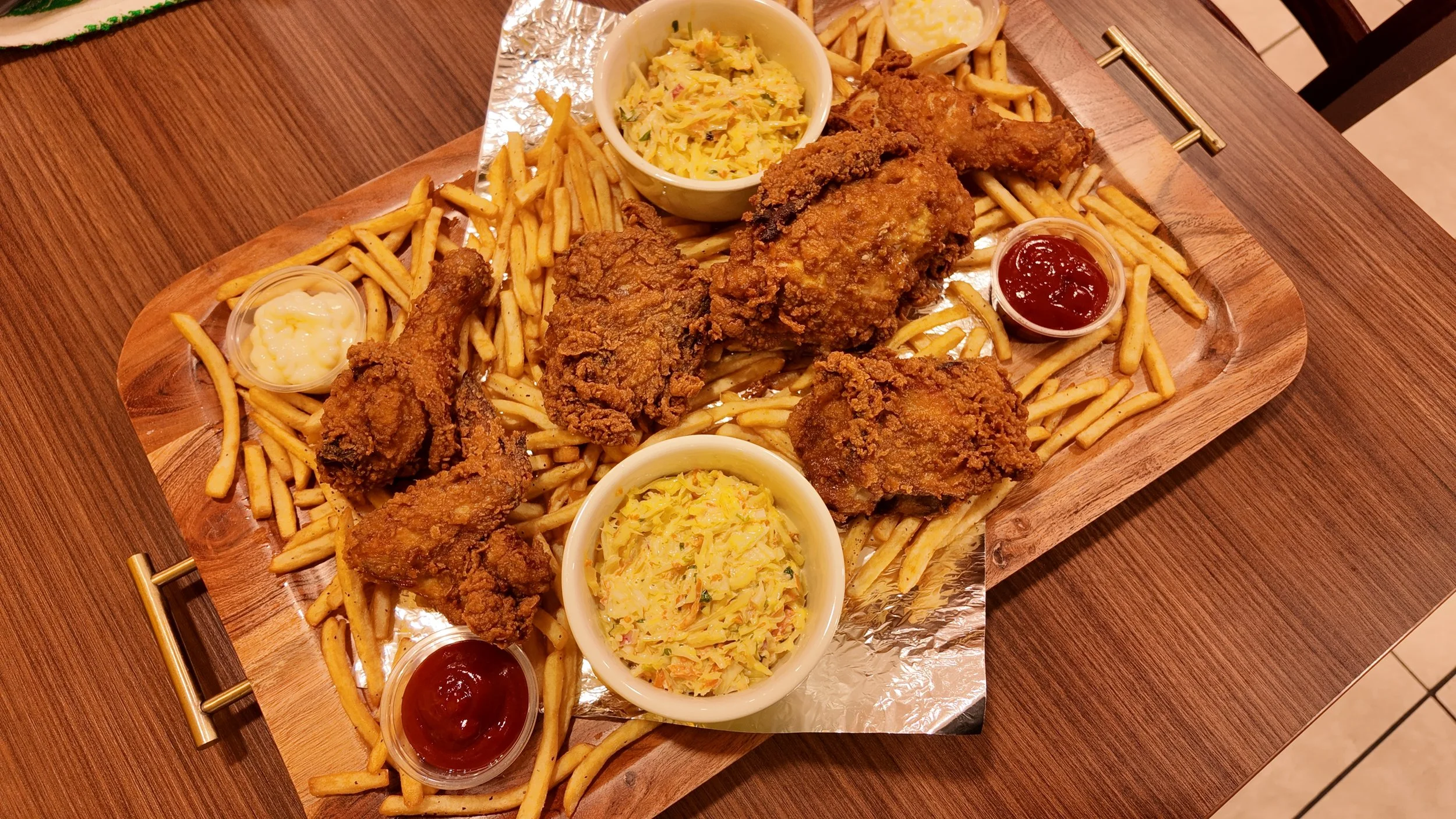Chickenlandia USA plate of the signature fried chicken, fries, and side dishes