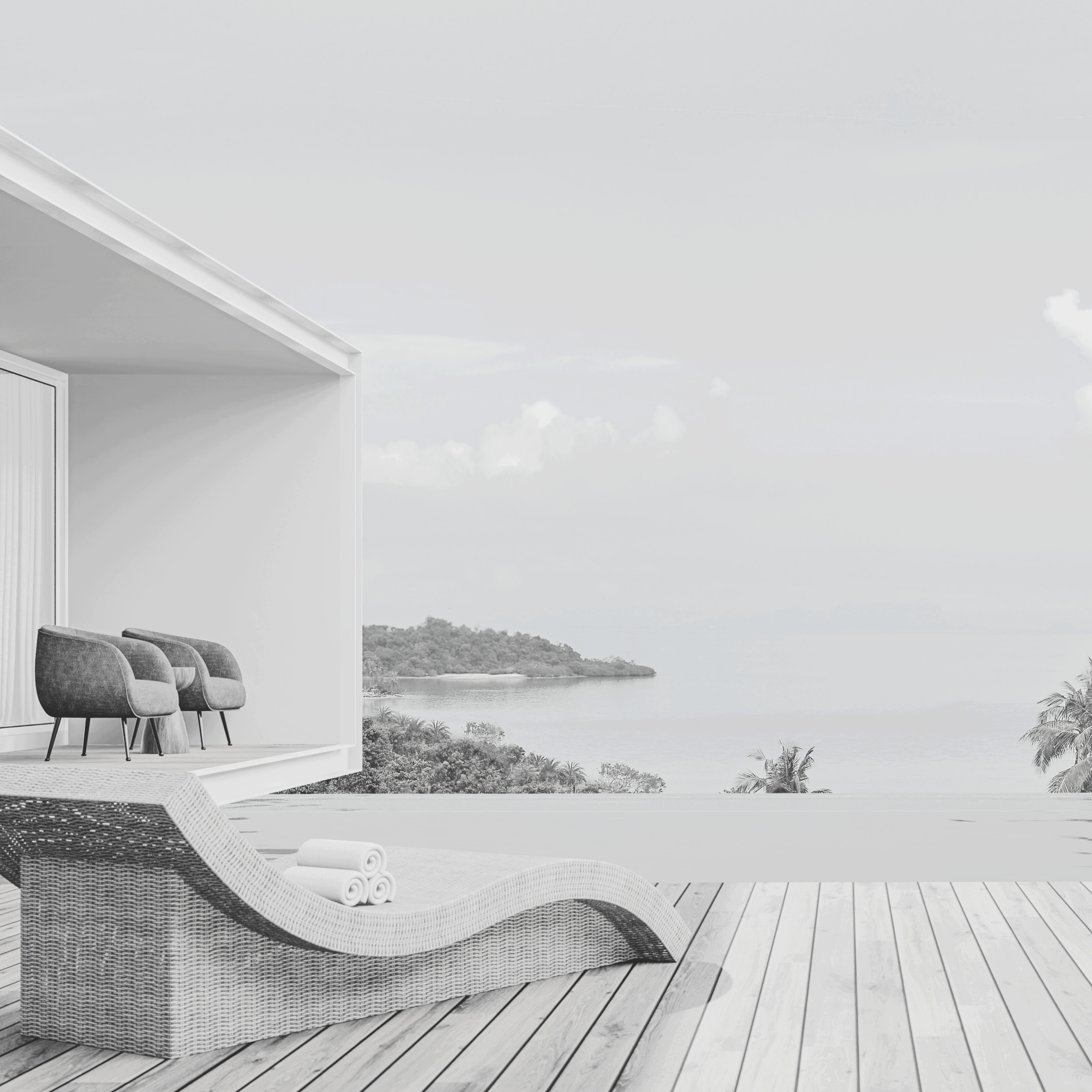 Outdoor patio with wicker lounge chair and rolled towels, overlooking a tropical landscape with water and palm trees.