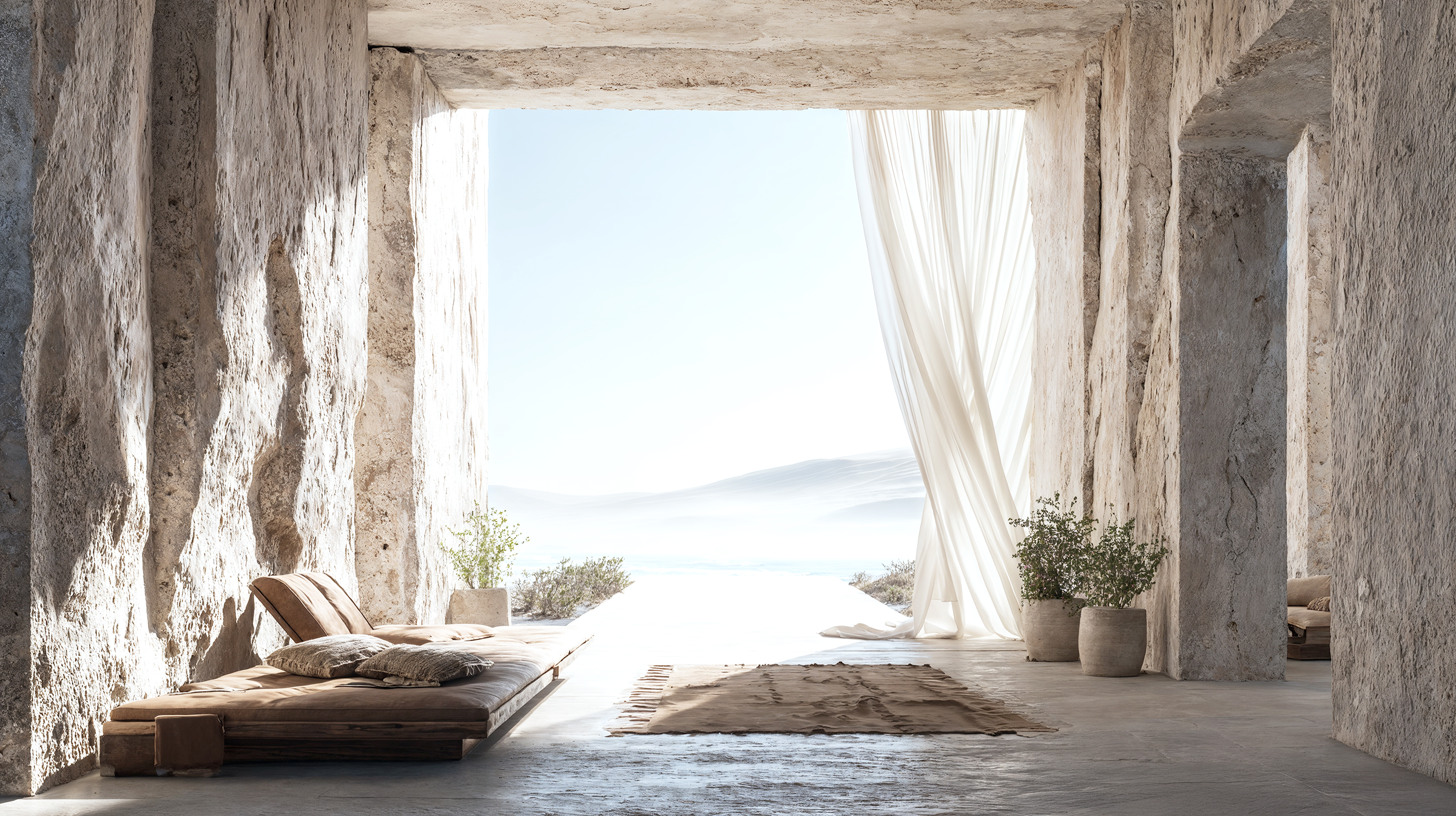 An open wall with a view of the outdoors, featuring a beige daybed with pillows, potted plants, a rug, and flowing white curtains, with a scenic landscape in the distance.