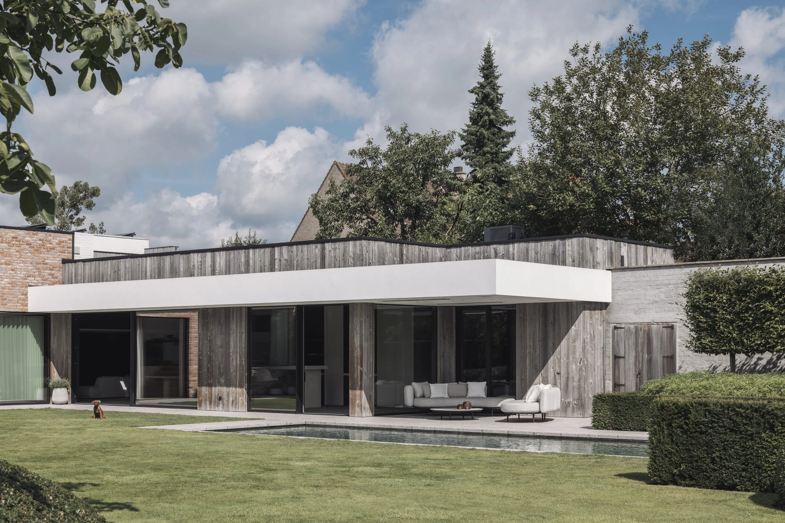 Bureau Destadsbader interior architecture high-end poolhouse design, exterior shot garden, pool, lounge