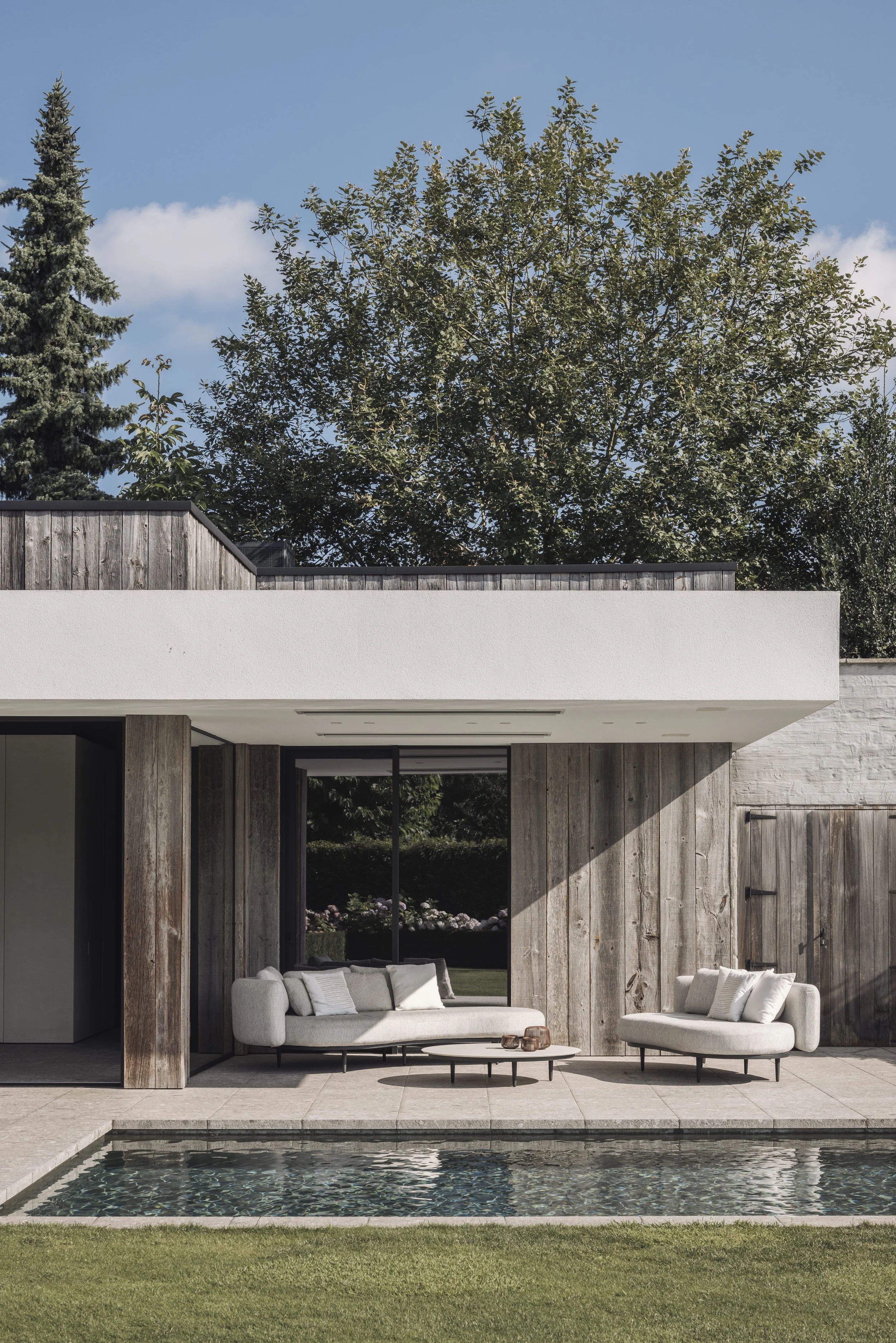 Bureau Destadsbader interior architecture high-end poolhouse design, exterior shot garden, pool, lounge