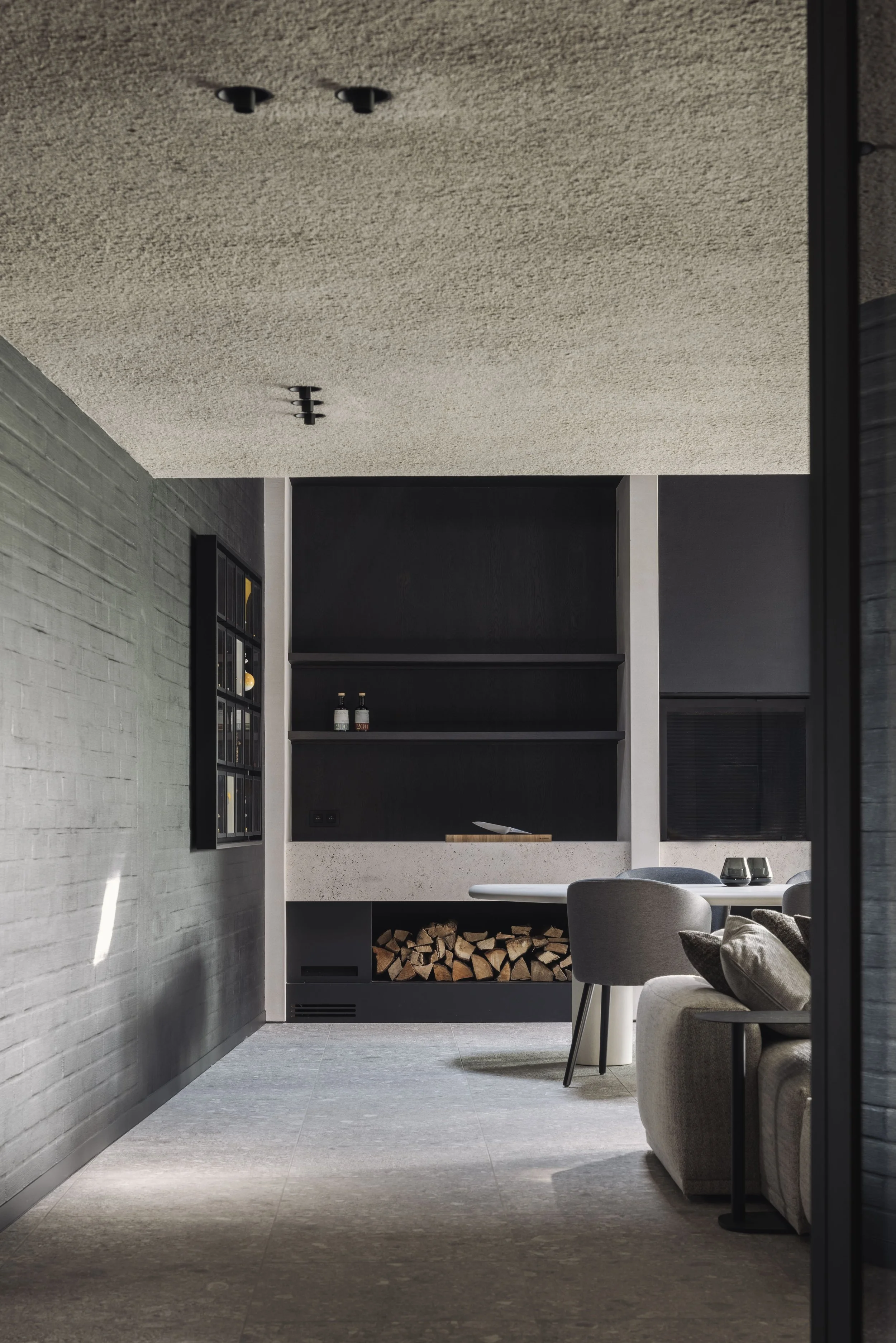 Bureau Destadsbader interior architecture high-end poolhouse design, interior shot cabinetry, fireplace, dining place